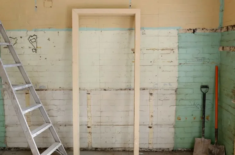 Interior demolition with walls stripped back and tools on site