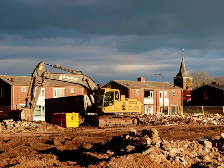 Excavator on a residential demolition site near homes, similar to Walnut Grove jobs in Vancouver, WA